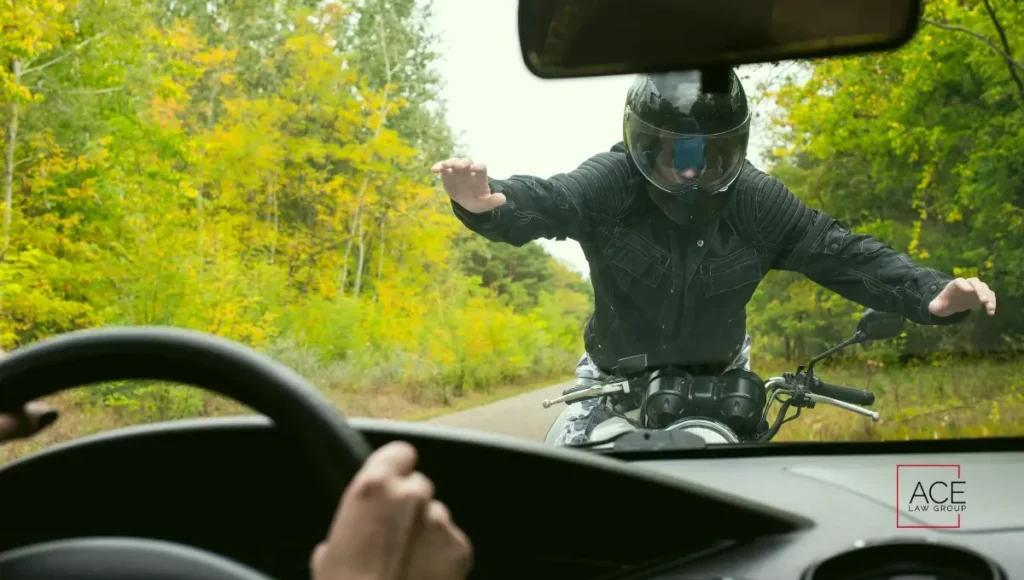 Scene showing a car and motorcycle involved in a head-on collision